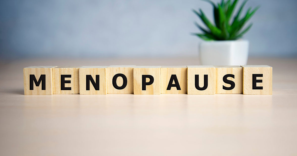 Letter blocks spelling out the word menopause on a table.