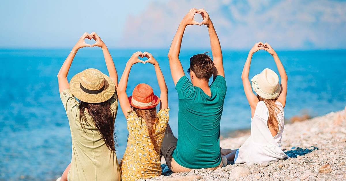 Family making heart shapes with their hands