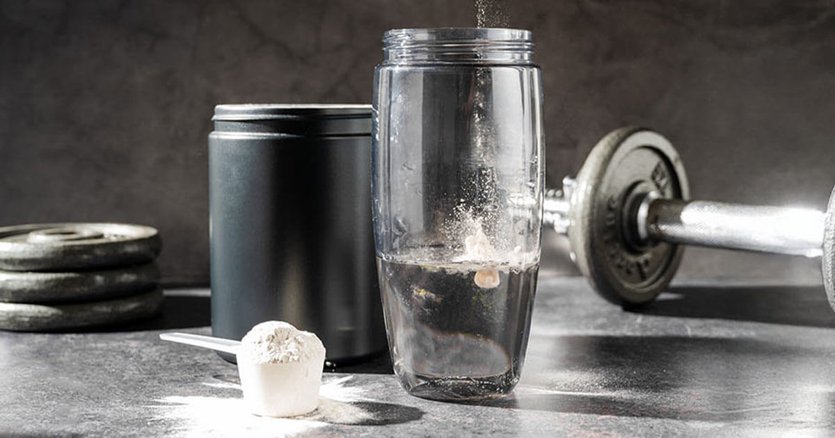 Creatine powder in a measuring scoop