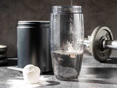 Creatine powder in a measuring scoop