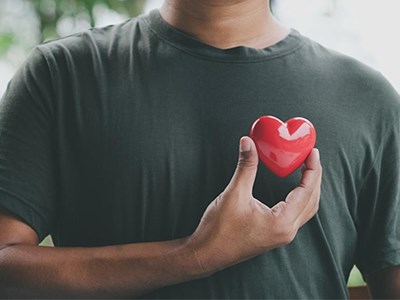 Hand holding red heart